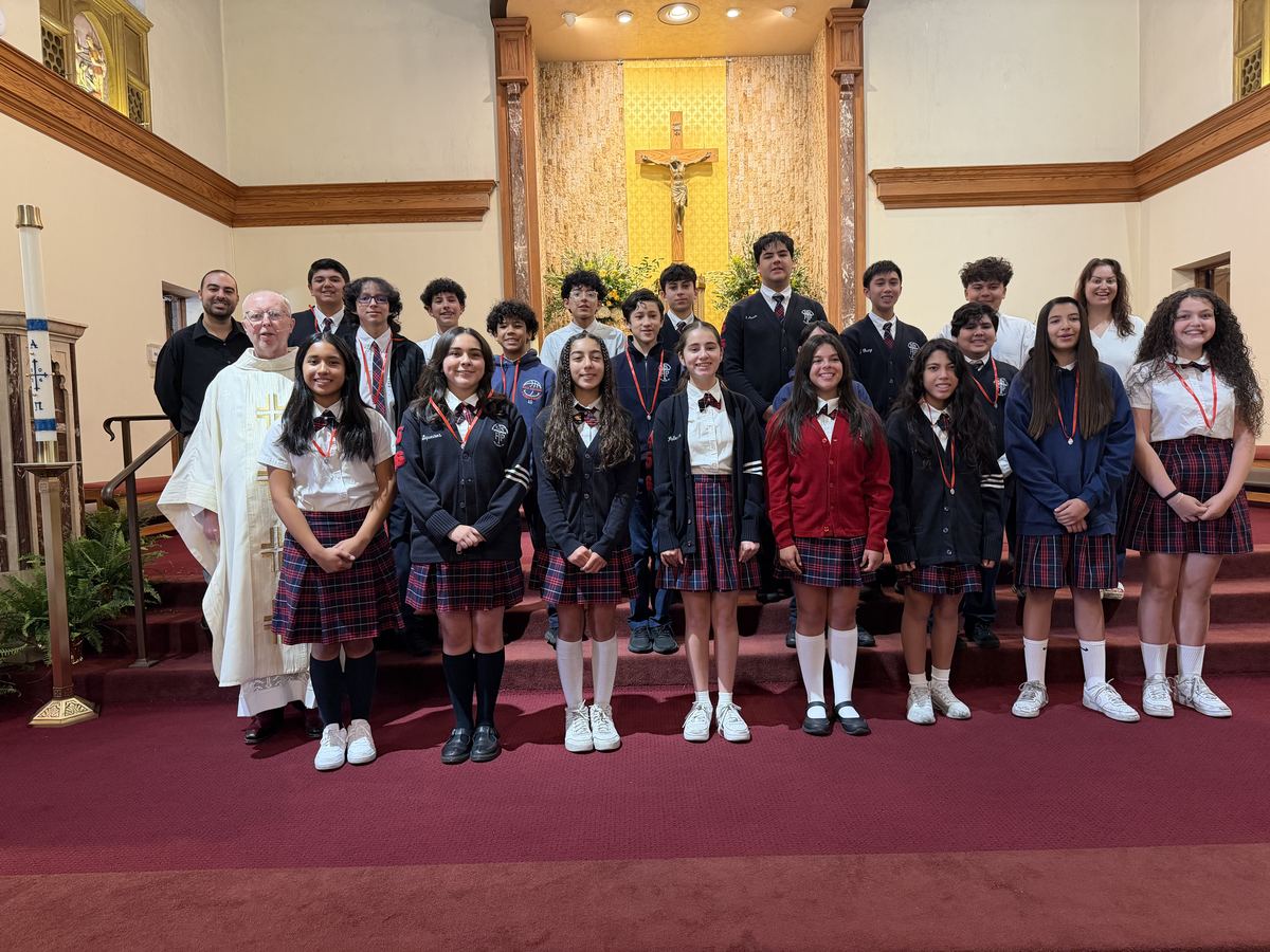 SSFP students in uniform standing with the pastor in front of the altar